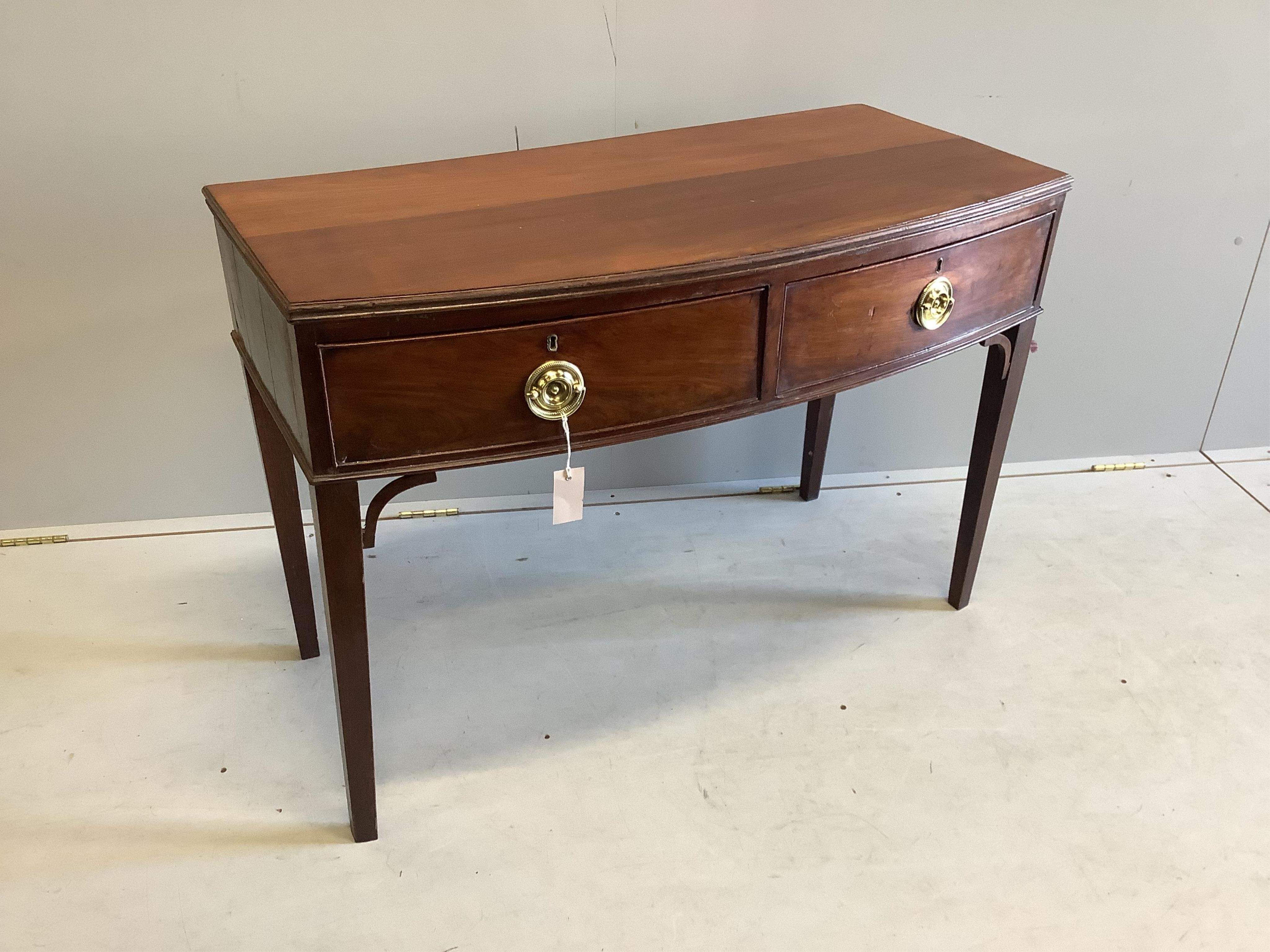 A George IV mahogany bow front two tier side table, width 103cm, depth 50cm, height 73cm. Condition - fair to good